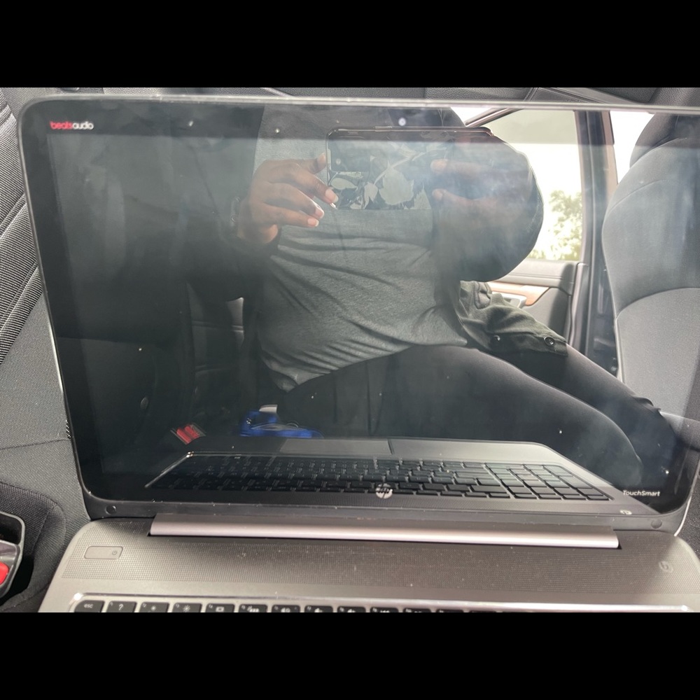 Slightly scratched HP laptop with Beats speakers.
